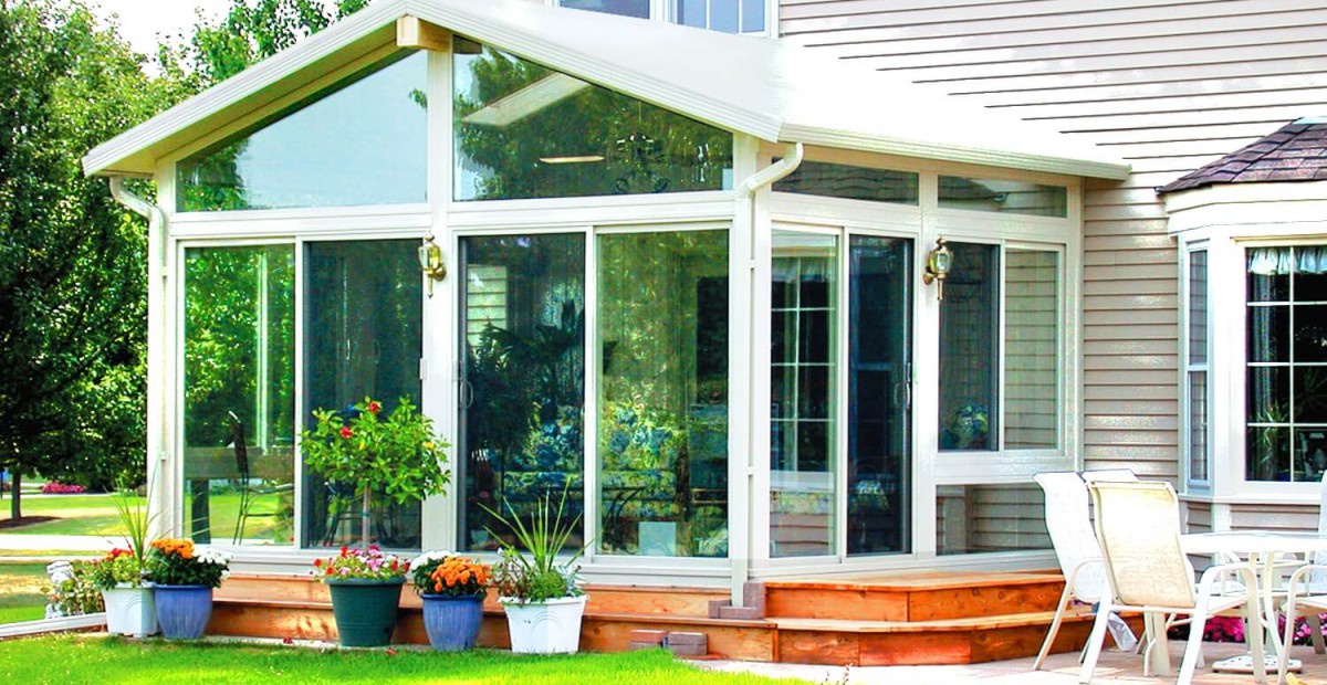 sunroom glass enclosure with wooden deck